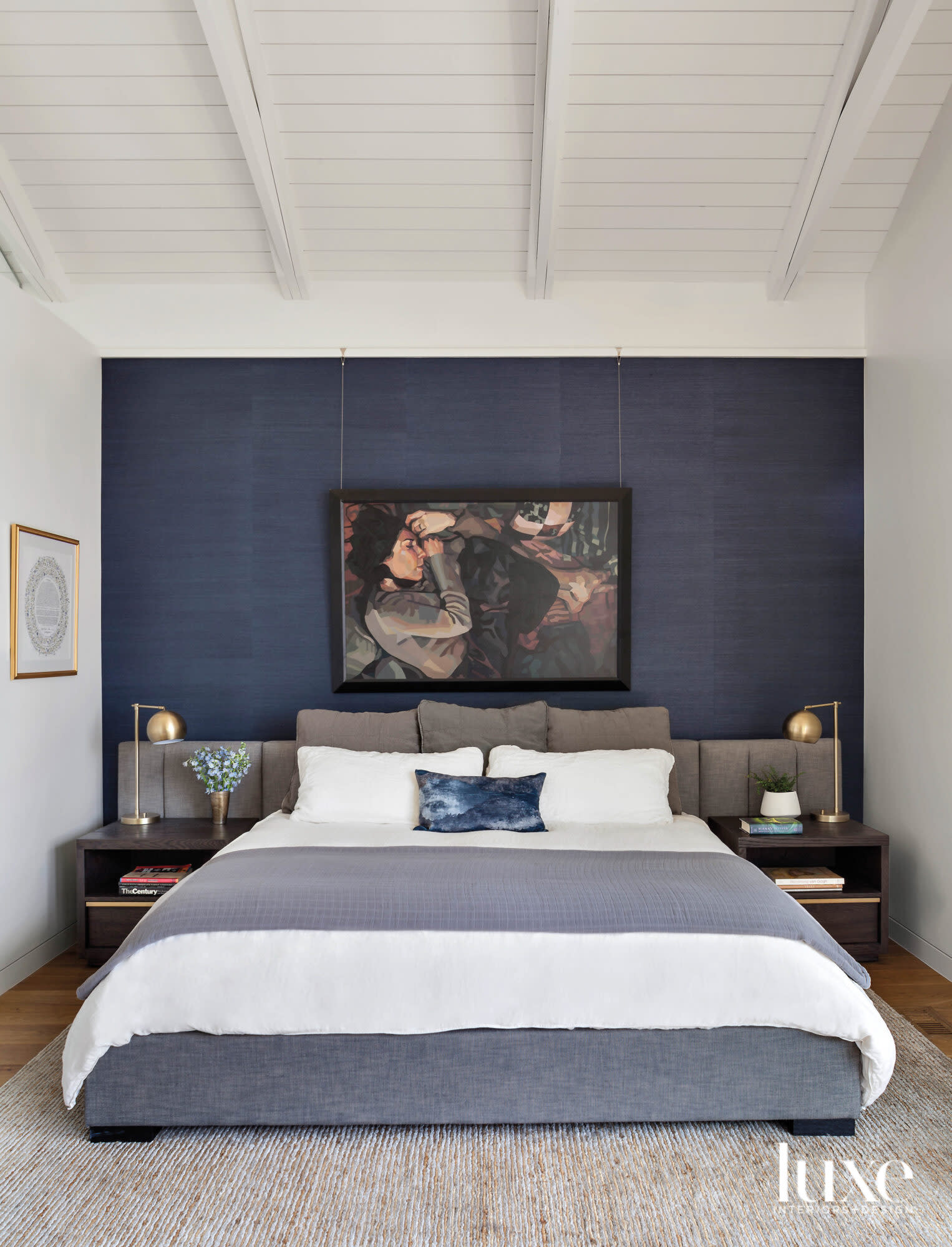 bed in front of blue accent wall