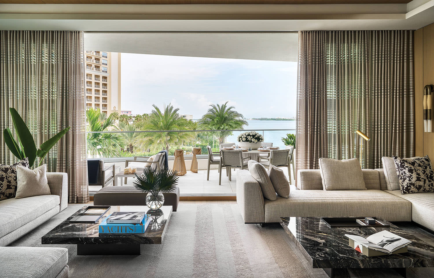 Sarasota home's living room with grey sectionals and waterfront views
