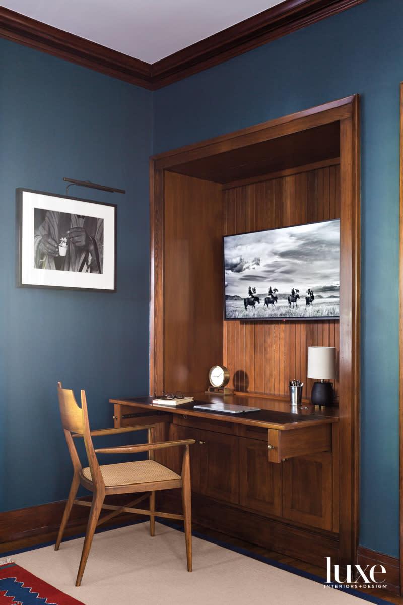 Detail of office with built in desk and blue painted walls