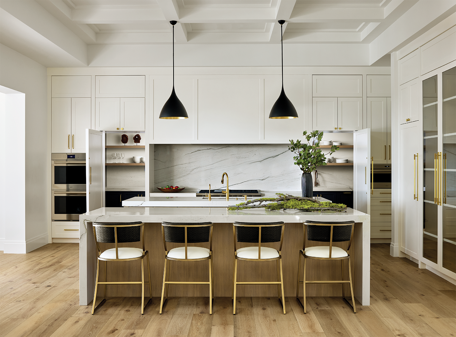 contemporary kitchen with a large island and white cabinetry 