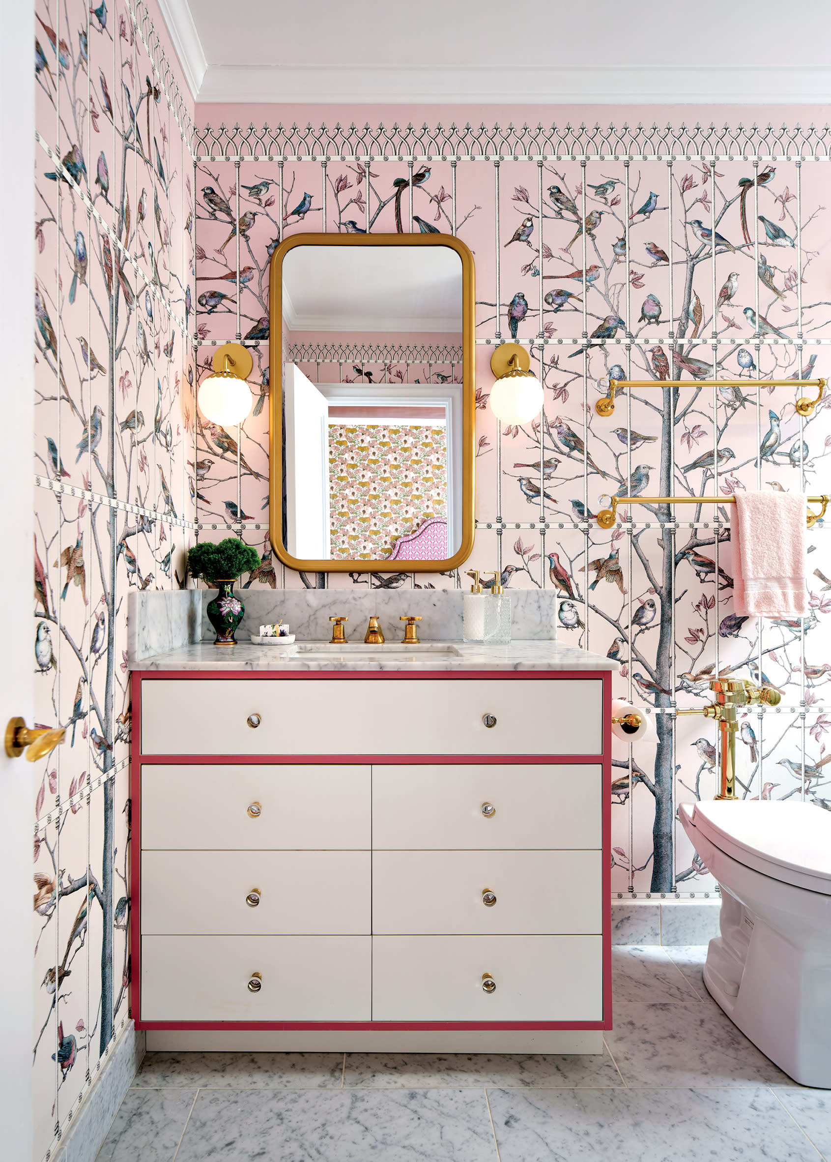 girly bathroom with pink bird and tree print wallpaper