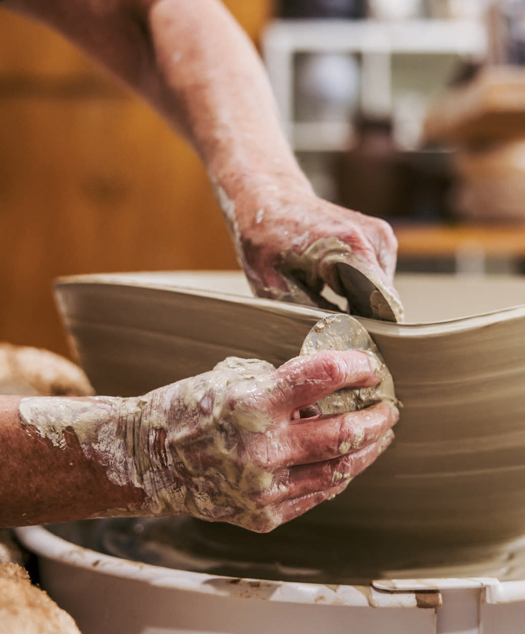 Caroline Blackburn works on a ceramic bowl