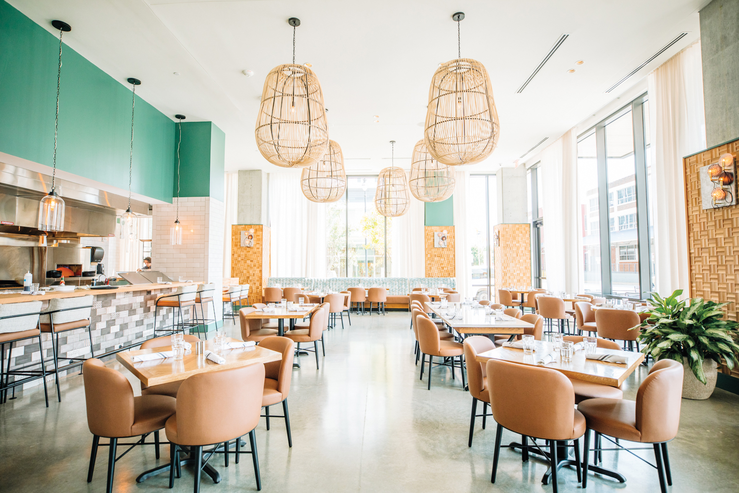 Airy restaurant dining room with basket-style pendant lights