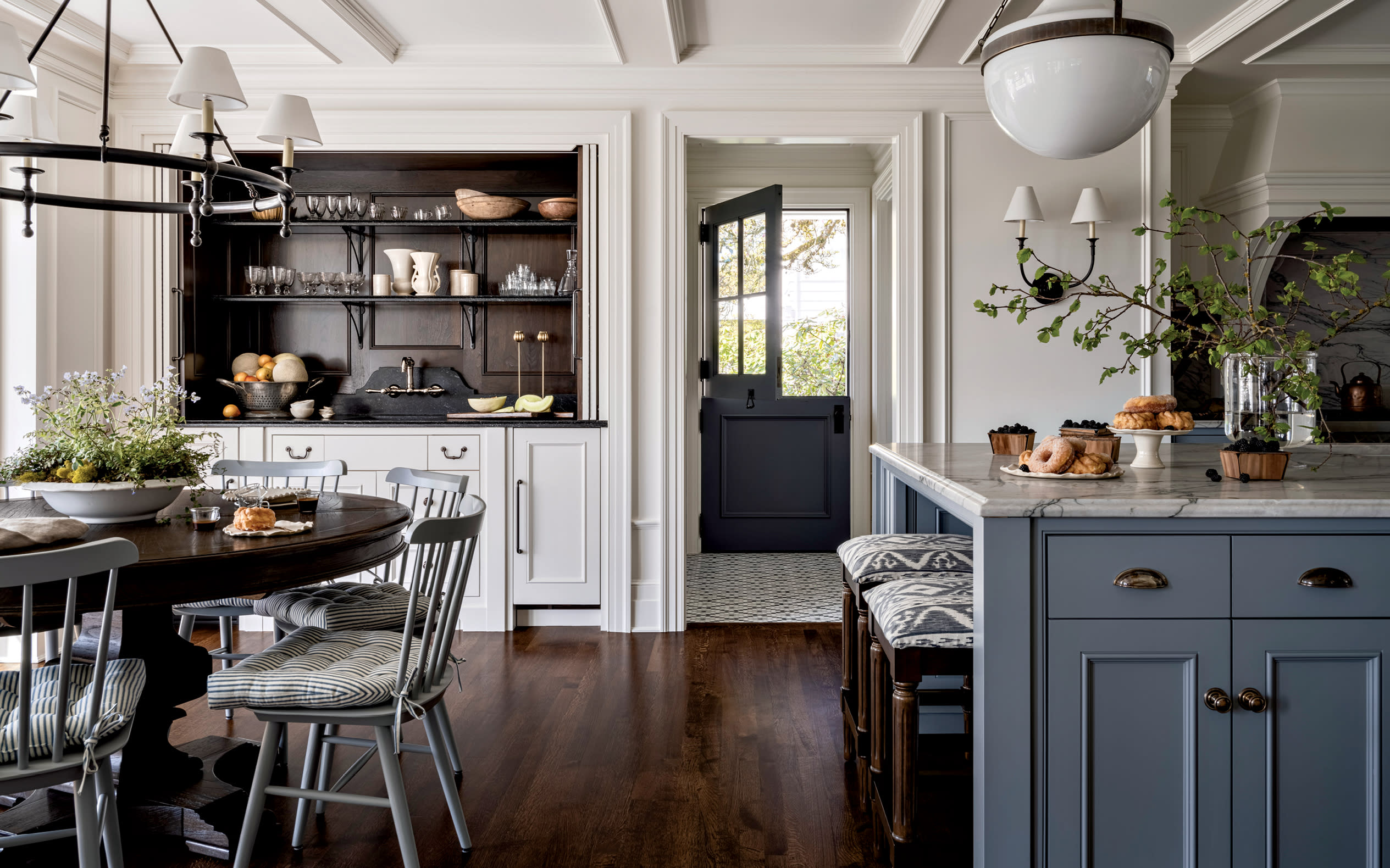 kitchen nook with traditional furnishings and a blue, stone-topped island