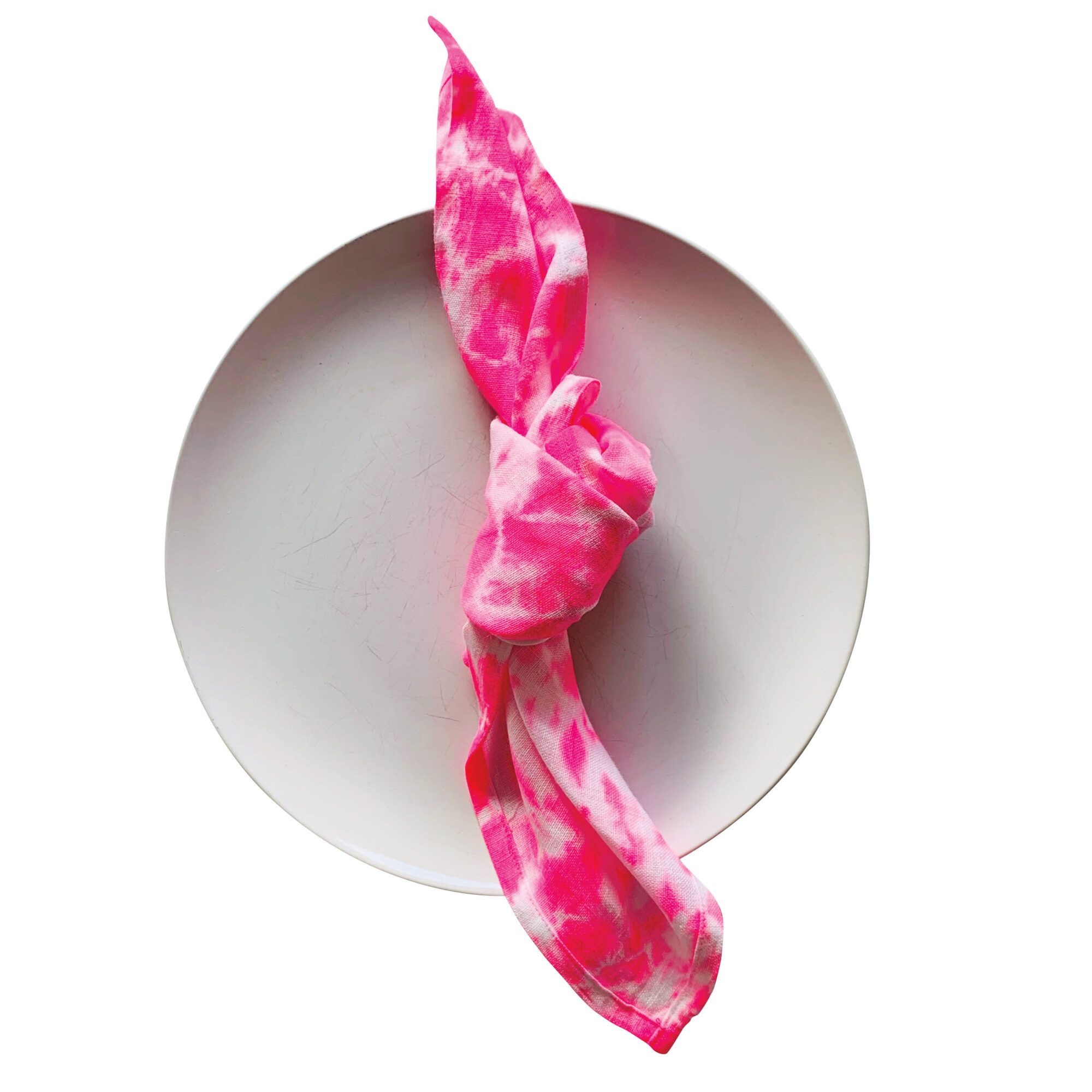 white plate with pink tie-dye napkin