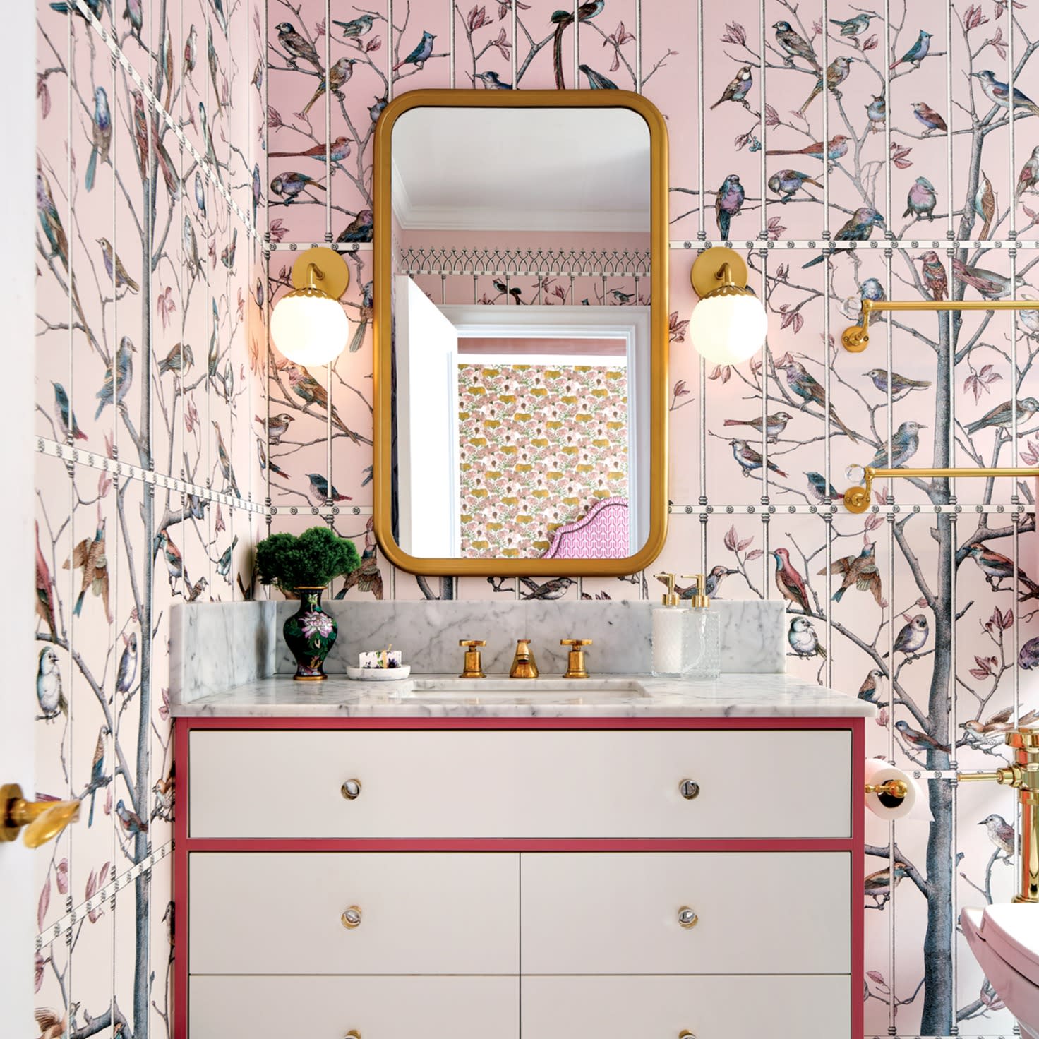 girly bathroom with pink bird and tree print wallpaper