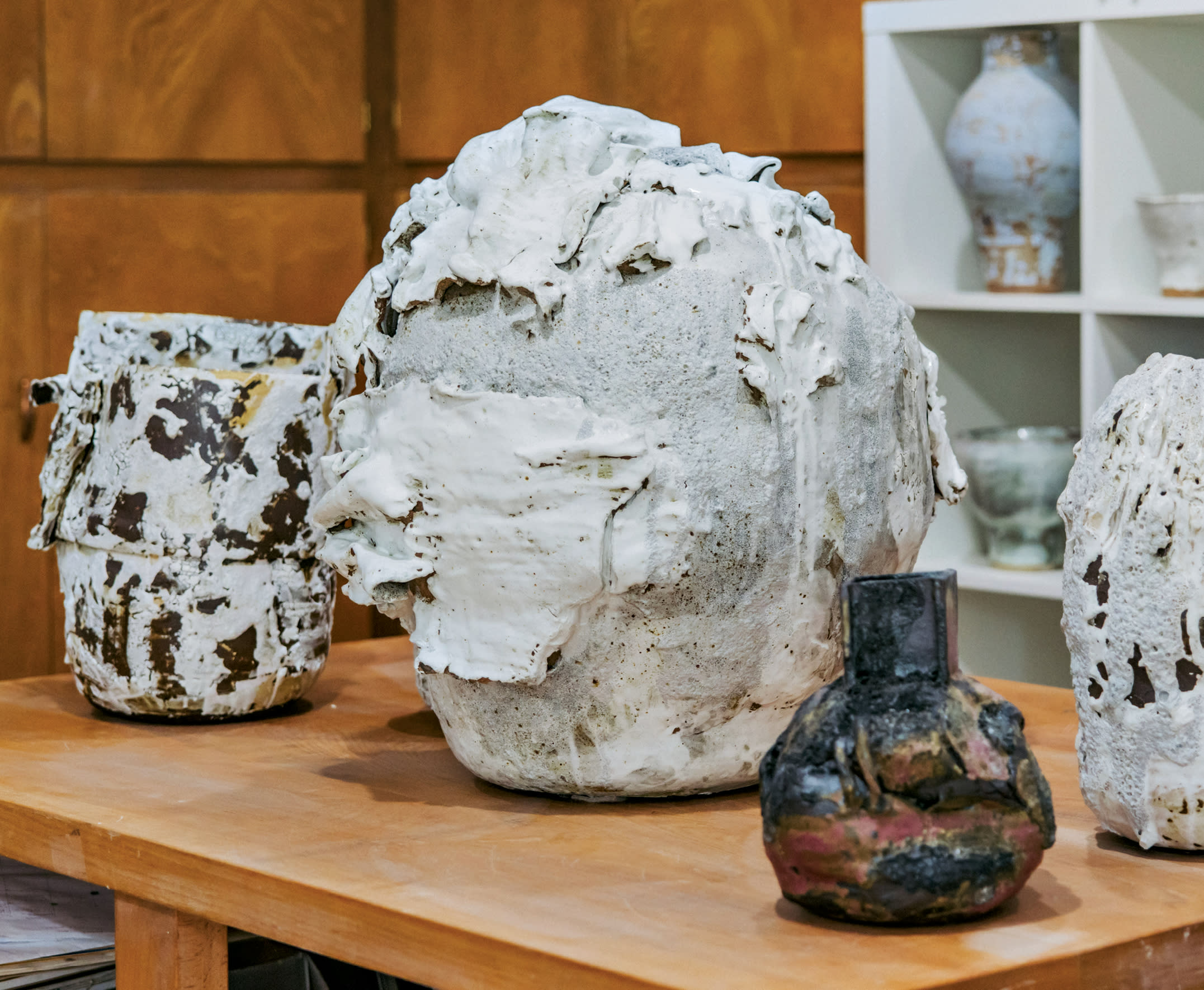 a collection of ceramic vases by Caroline Blackburn