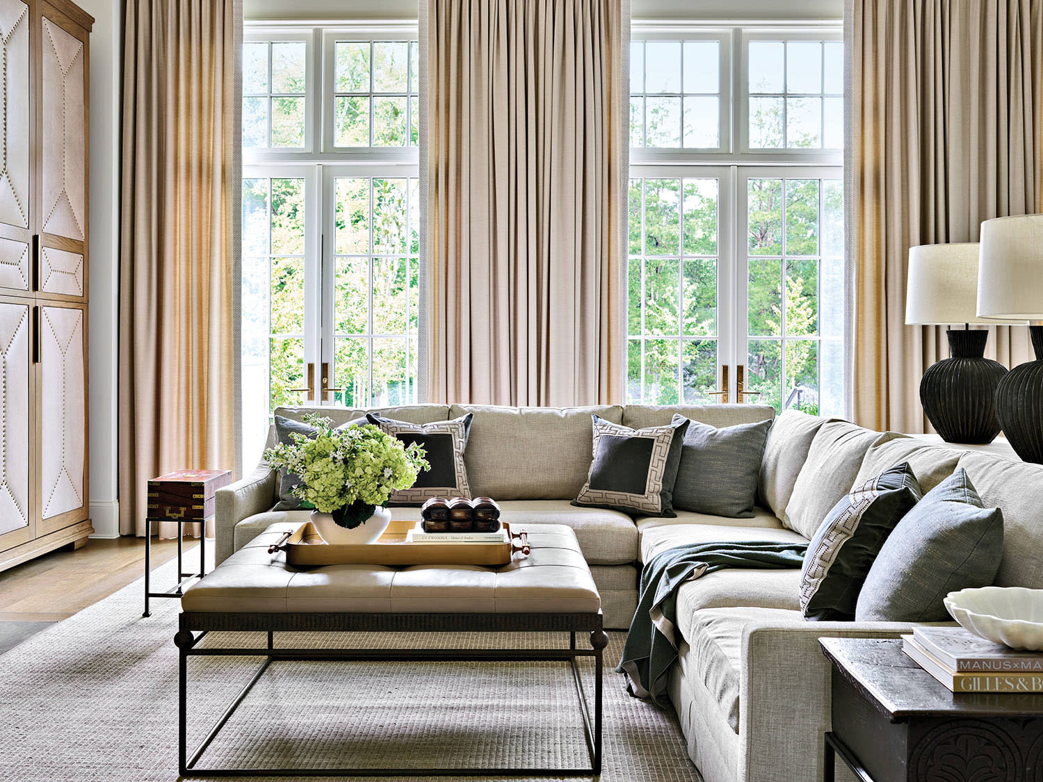traditional family room with white drapery and a large sectional