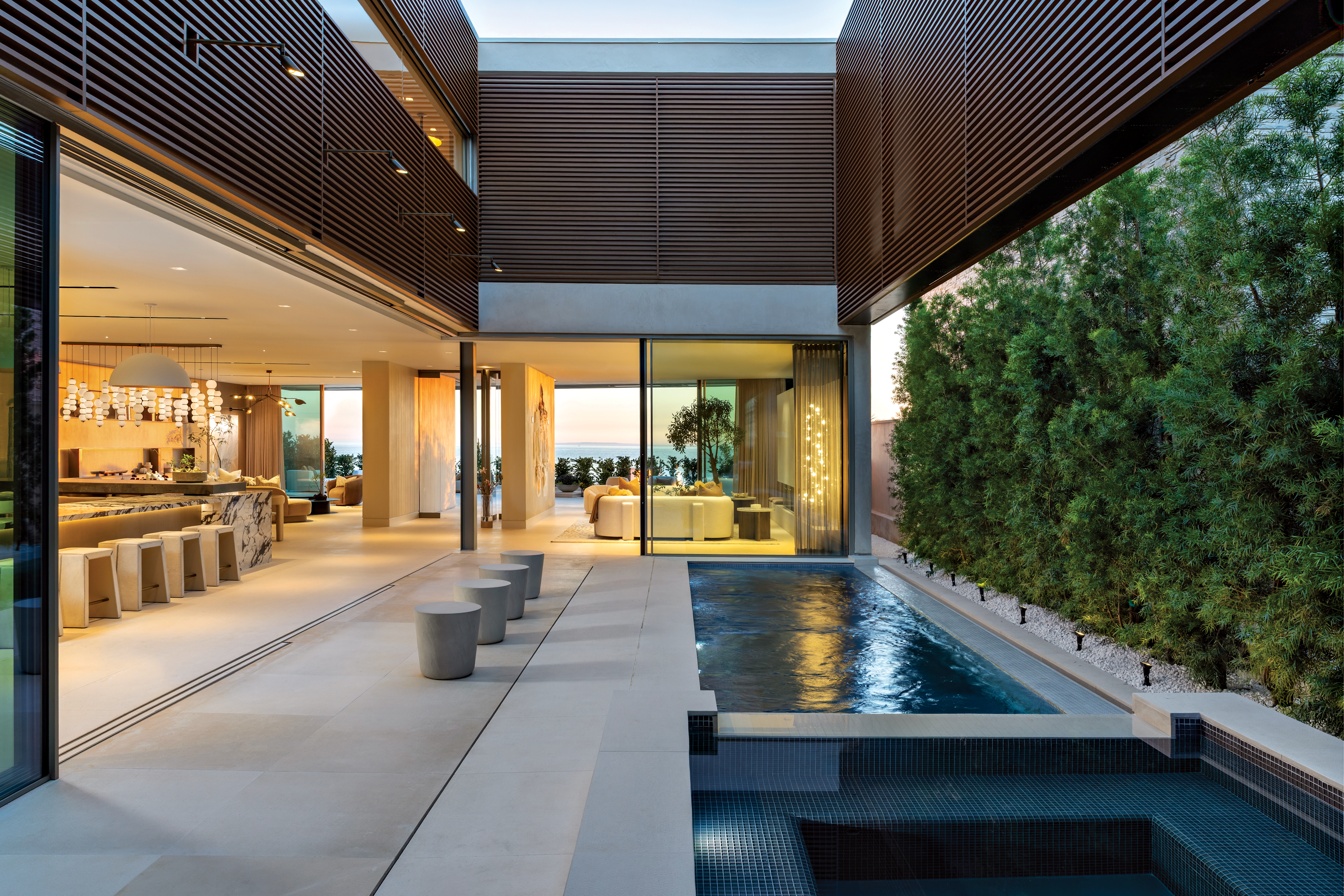 Courtyard with pool and spa seamlessly connecting indoor and outdoor living spaces.