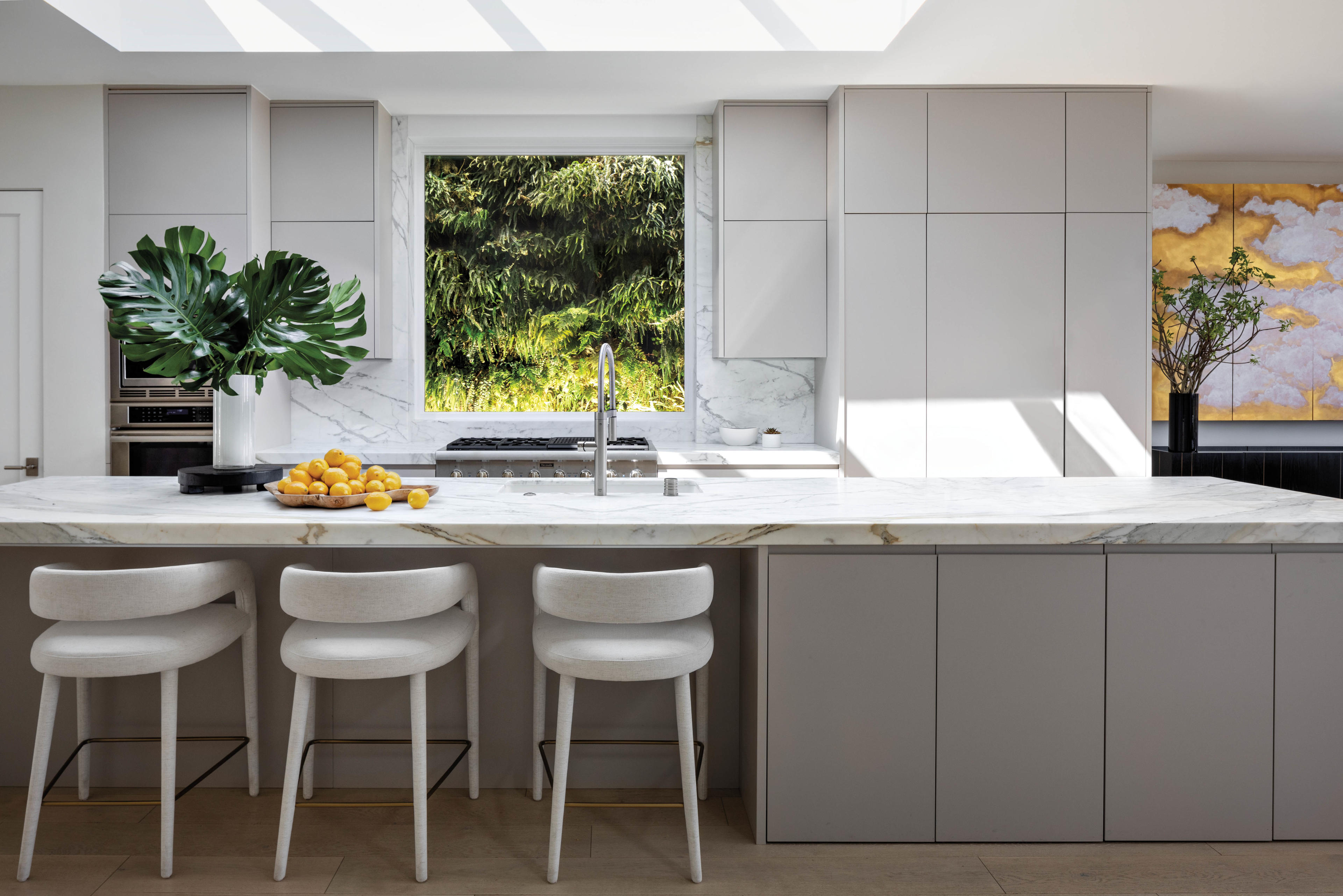 sleek modern kitchen with big island and cb2 barstools 