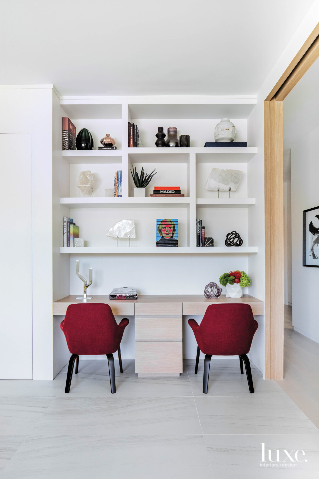 Children's homework area with a white oak desk and red chairs.