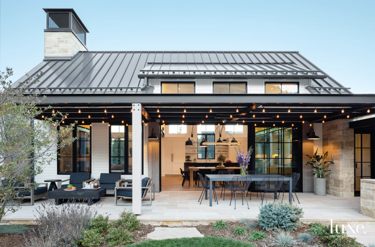 back exterior of the home features the landscape architecture, sitting areas and lights