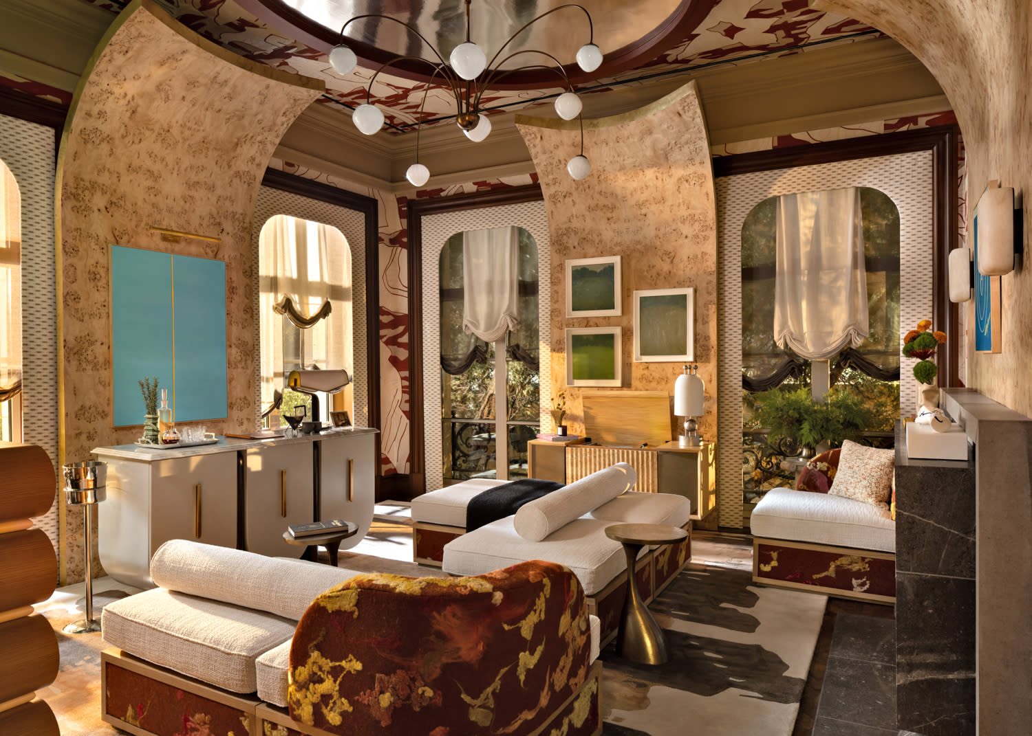 Luxurious living room with ornate arches, abstract wall art, plush sofas, and floor-to-ceiling windows