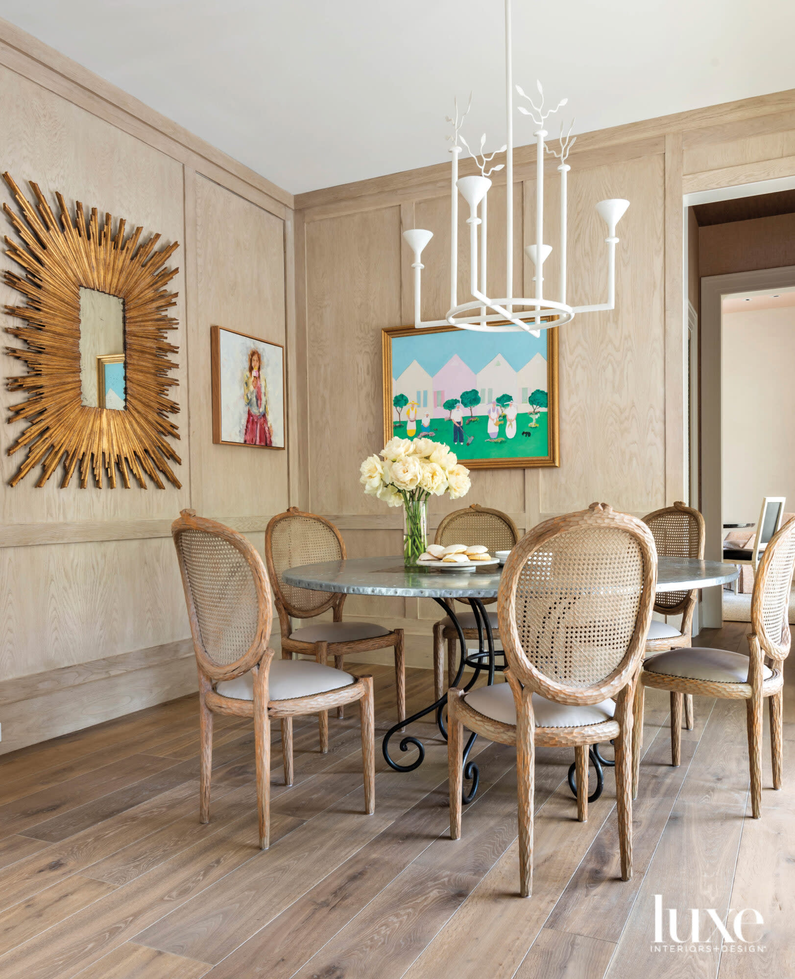 White oak paneled breakfast room with colorful art