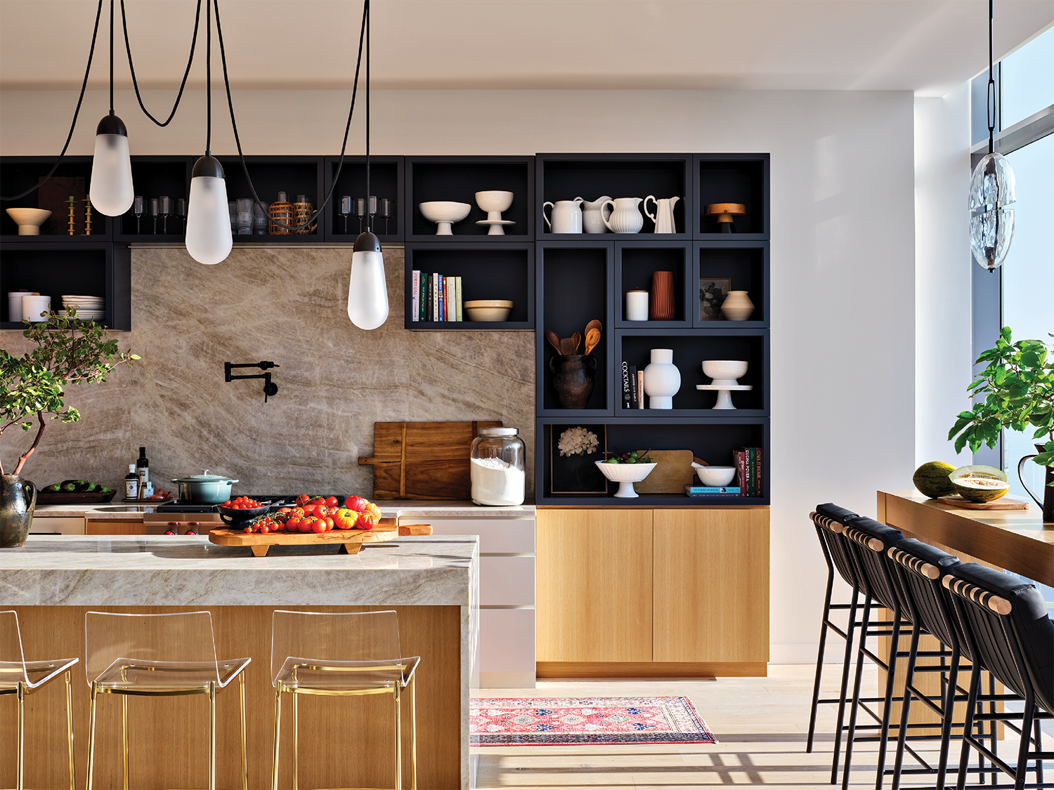 penthouse kitchen with black open-shelving and a quartzite backsplash