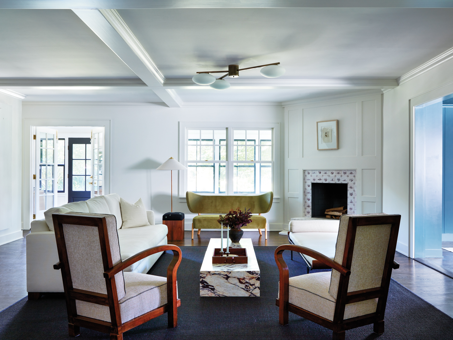 living room with marble coffee table, couches, and armchairs
