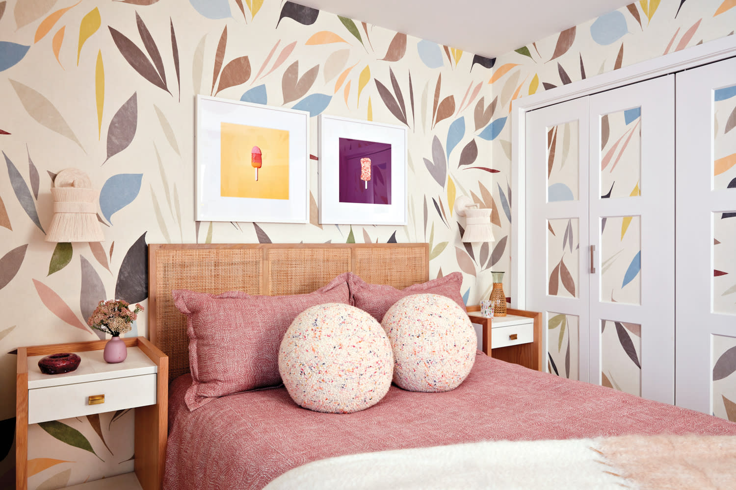 modern guest bedroom with a large-scale floral wallpaper and cane bed frame