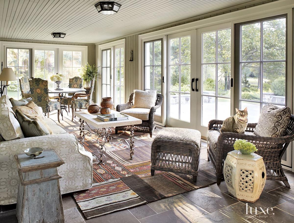 Transitional Neutral Sunroom with Kilim Rug | LUXE Interiors + Design