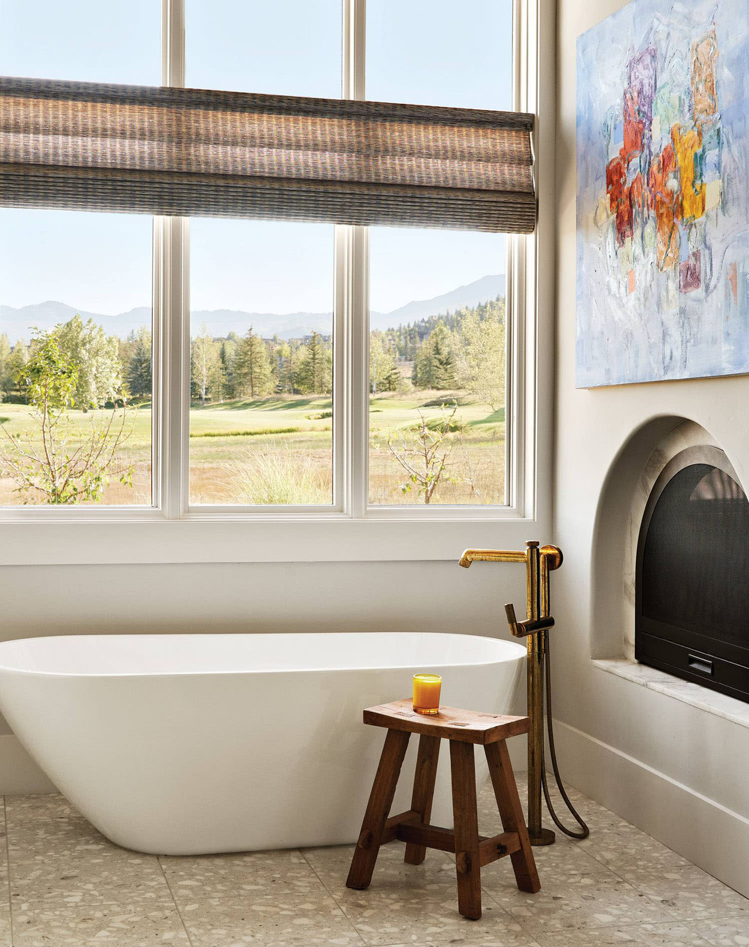contemporary bathroom with modern artwork and a vintage stool
