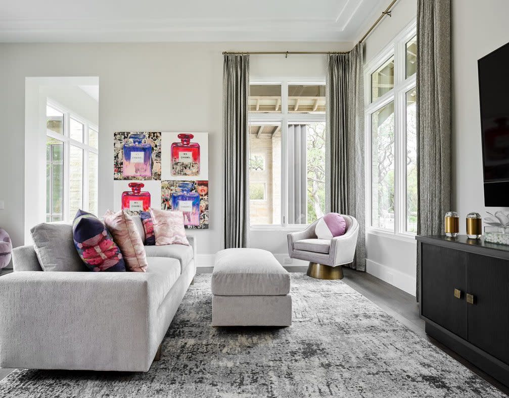 Neutral living room featuring bright colored art work.