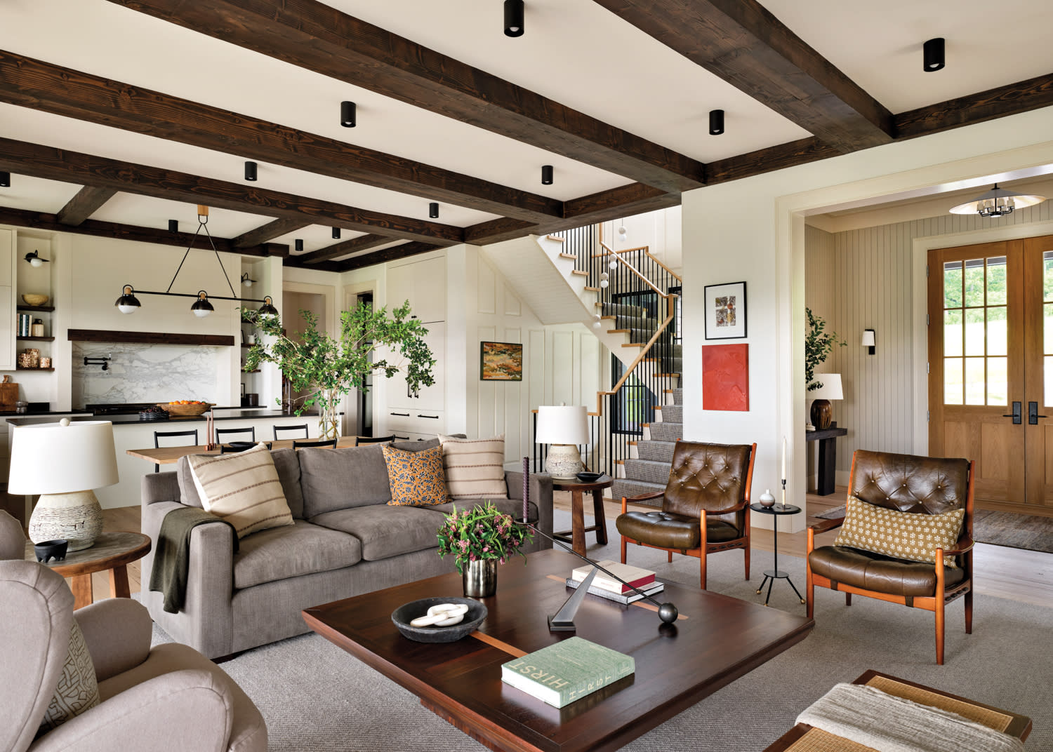 Living room with grey sofa, wooden coffee table and wooden beam ceilings