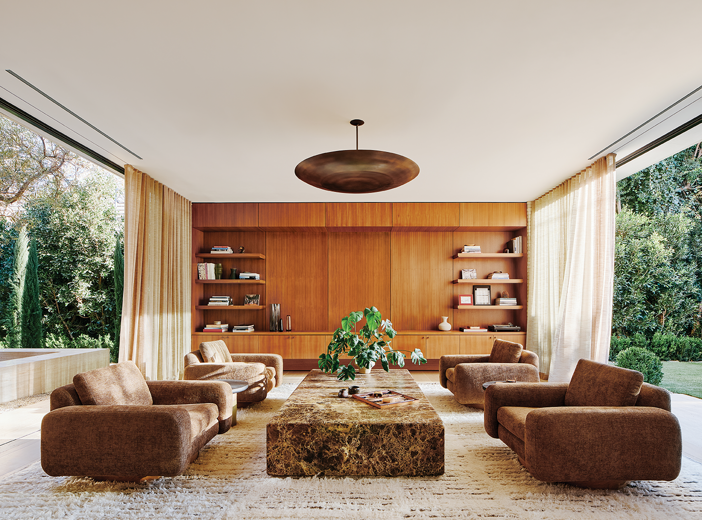 brown modern living room with paneling and marbled stone