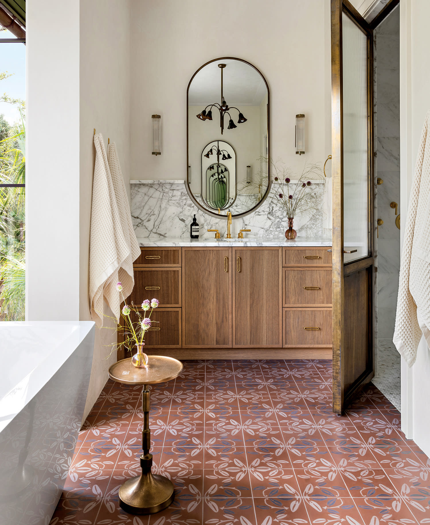 modern bathroom with patterned terracotta floor tiles