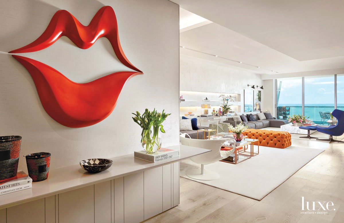 modern entryway and living room red lip sculpture on wall