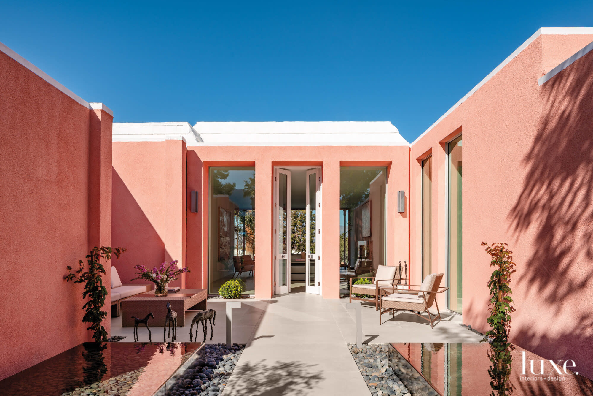 Front entry to a Palm Desert house with pink stucco finish on exterior walls