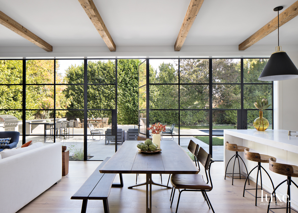 kitchen with floor to ceiling windows and farm table