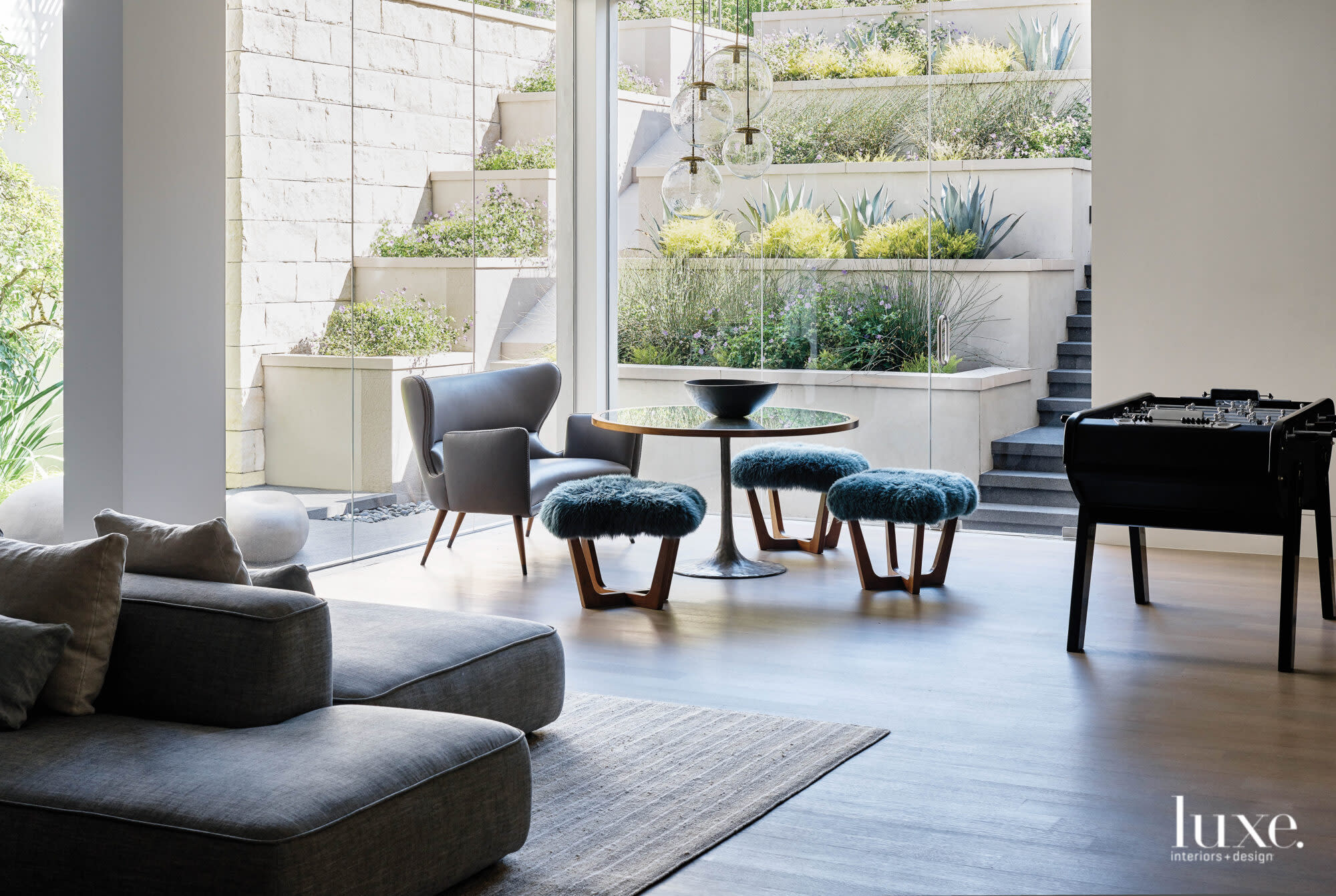 A lower-level seating area looks out to a terraced planting area.