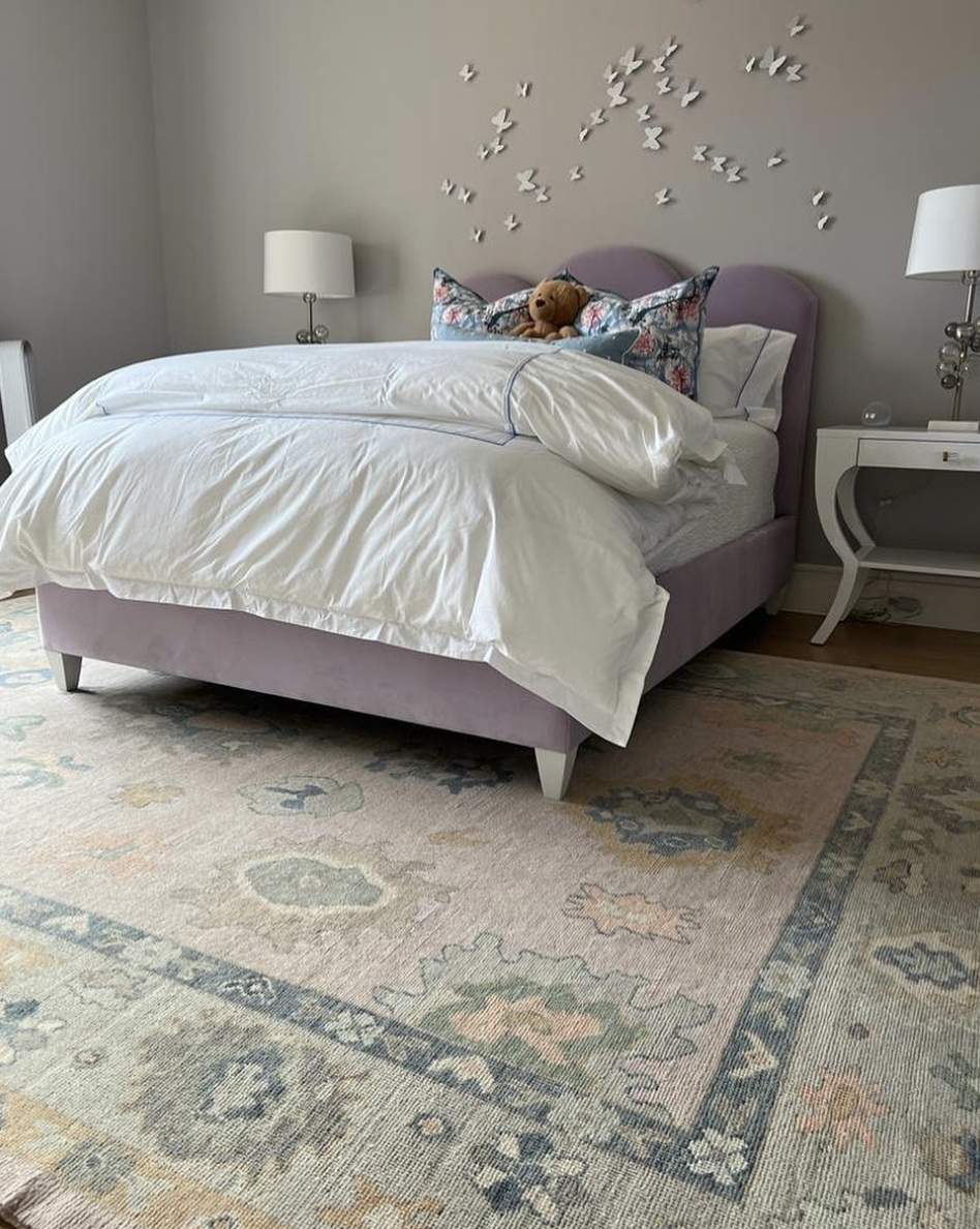 Large Turkish rug featured in a bedroom.