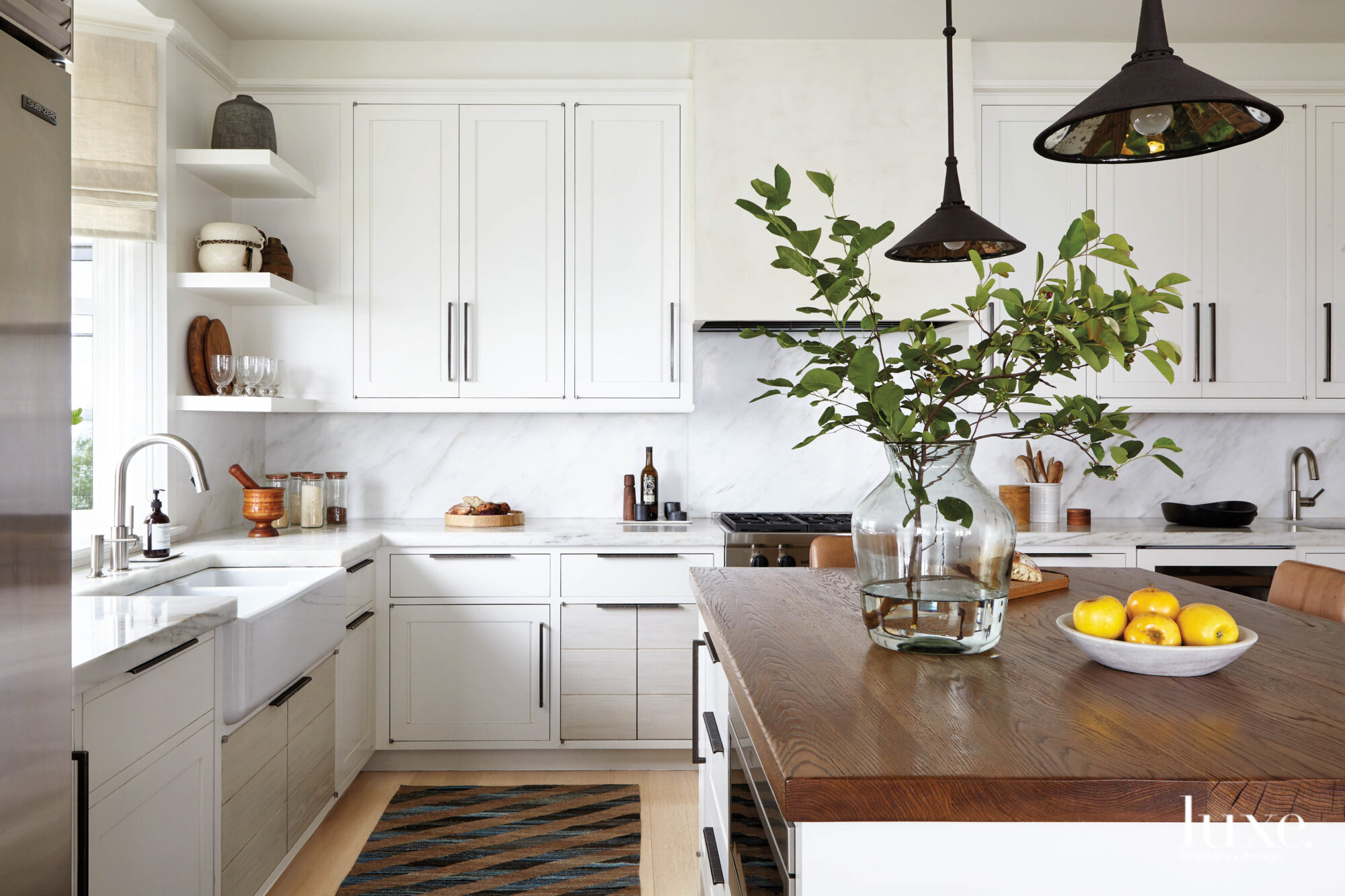 kitchen with custom wood cabinetry and reclaimed oak island