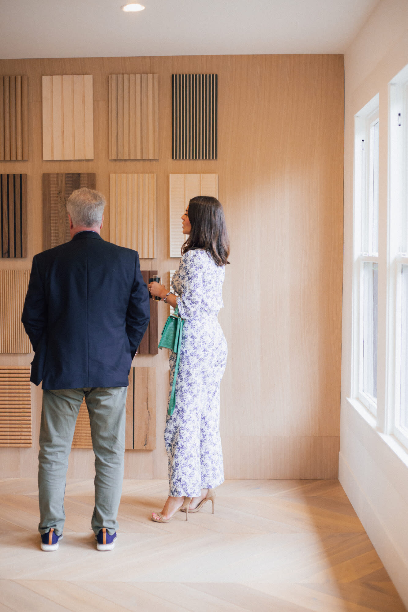 man and lady looking at wood wall