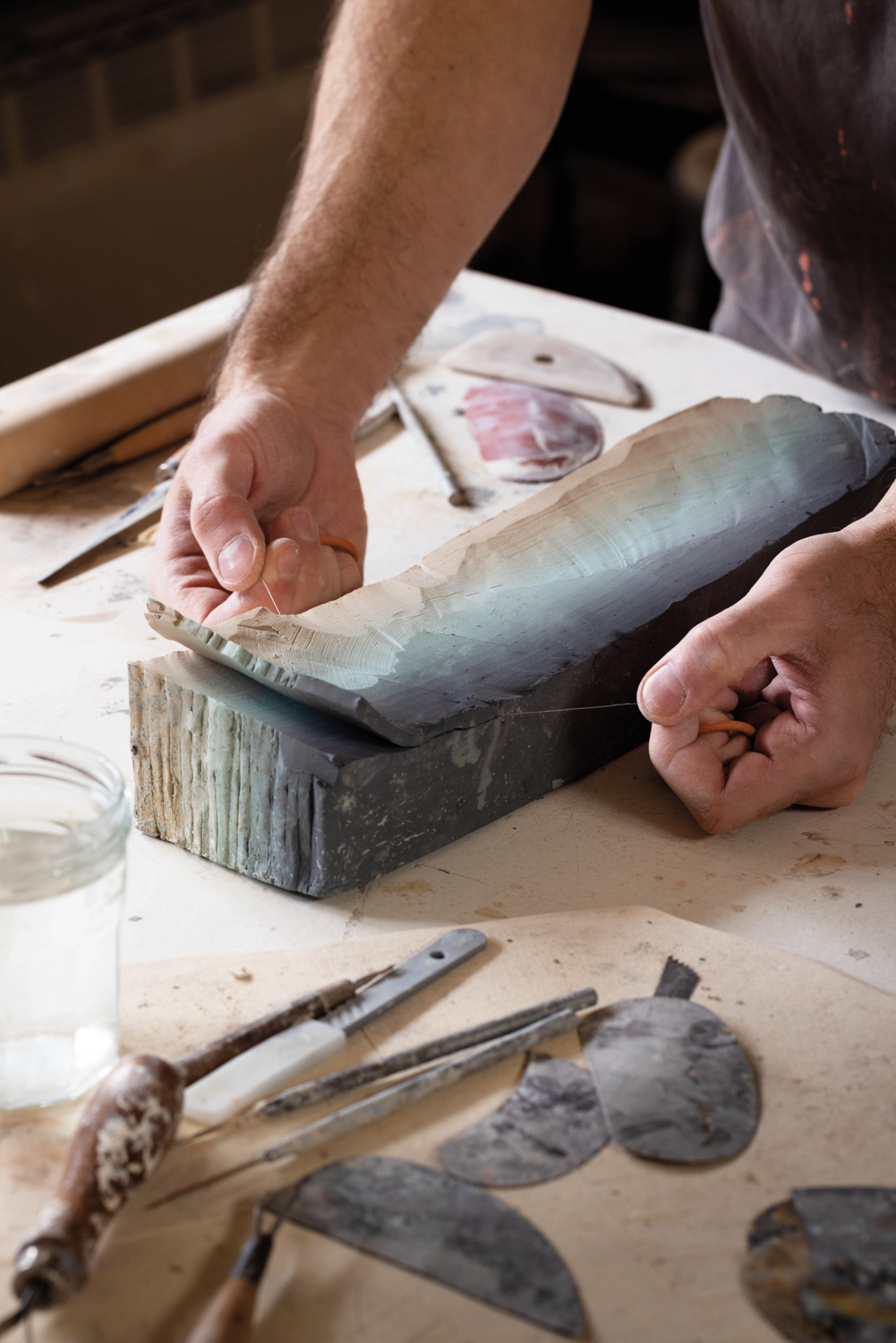 a large slab of clay on a desk being worked on by Cody Hoyt