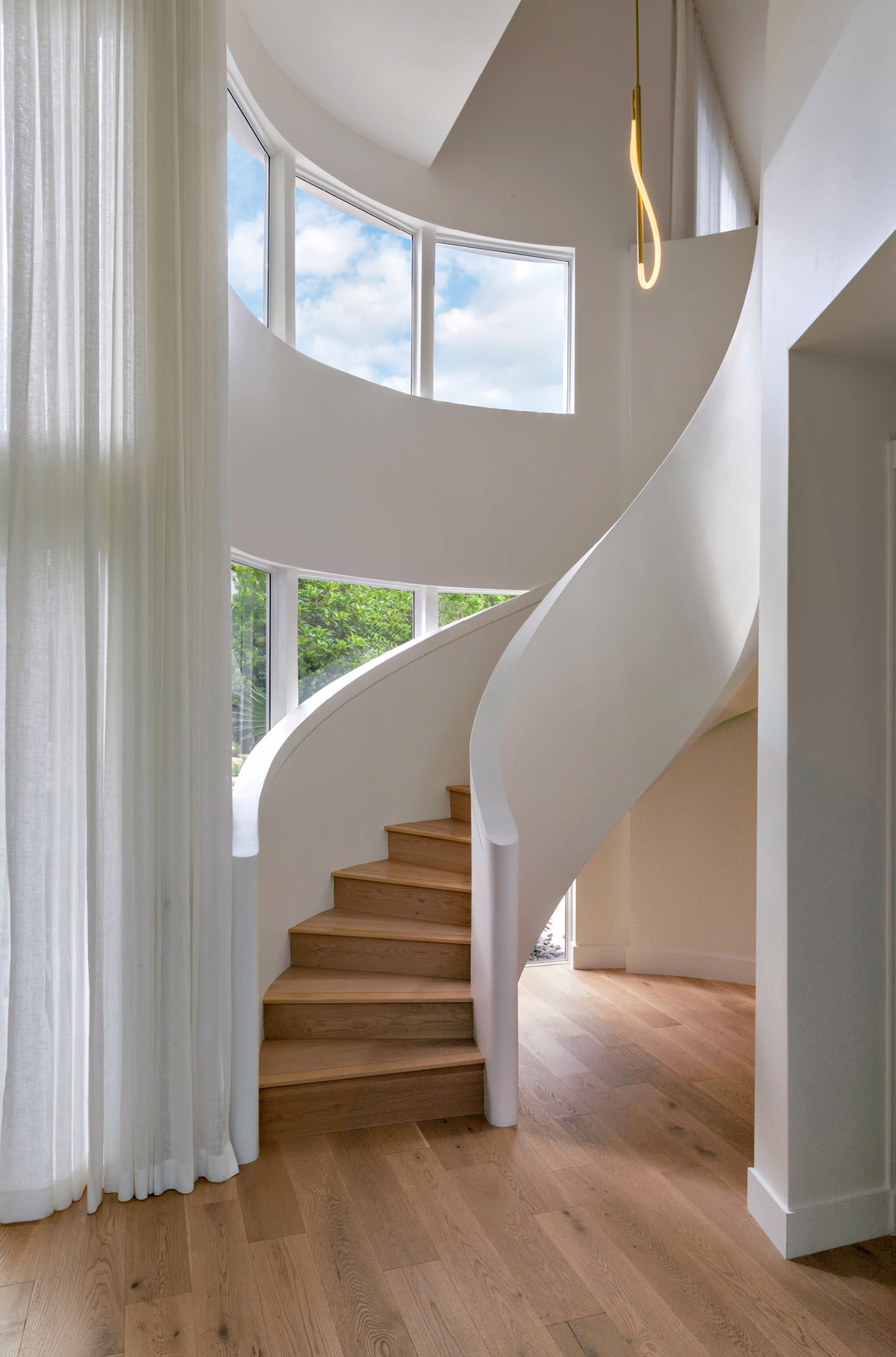 contemporary stairway with light wood flooring and treads