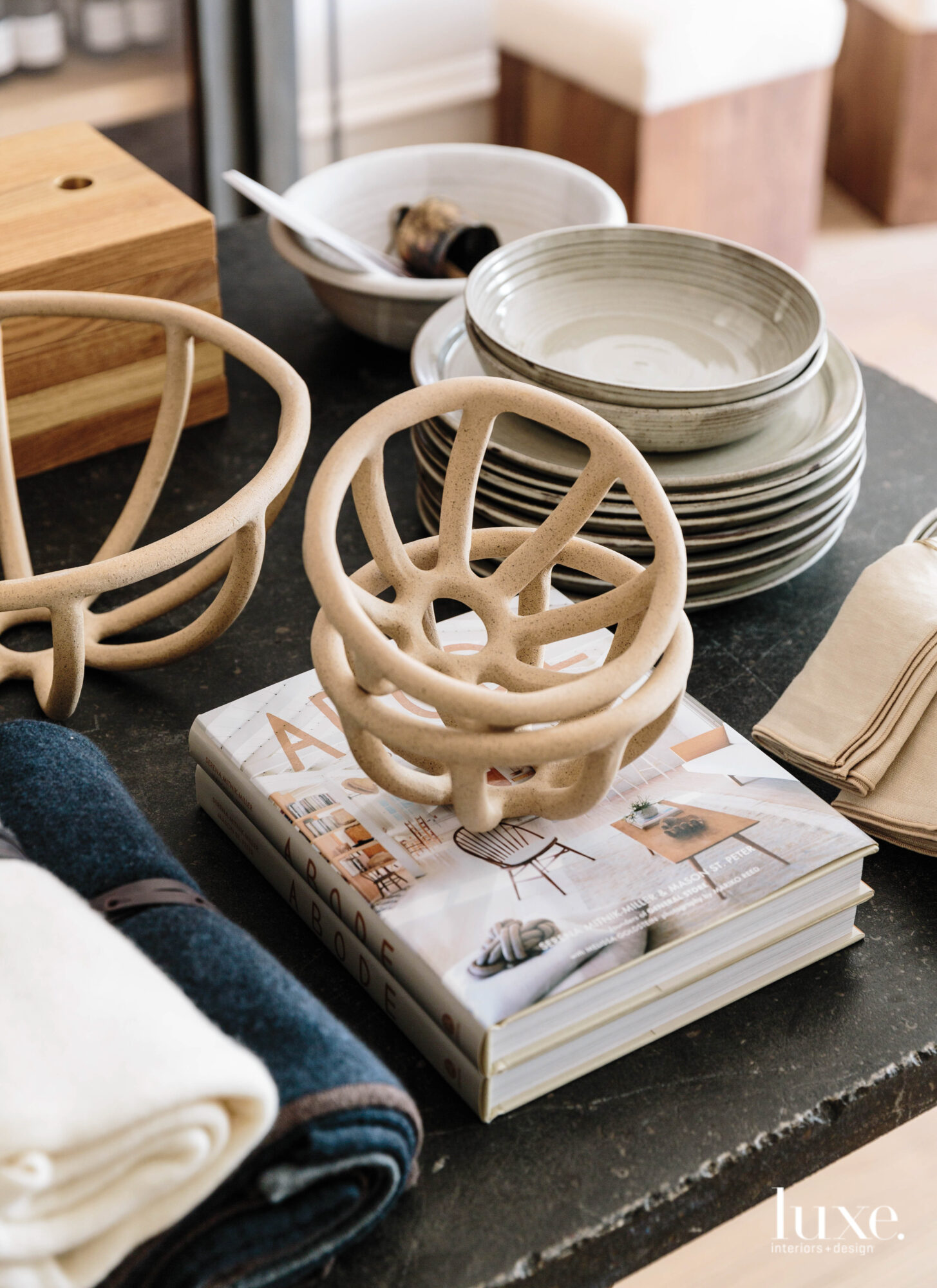 A trio of modern fruit bowls sits on a table.