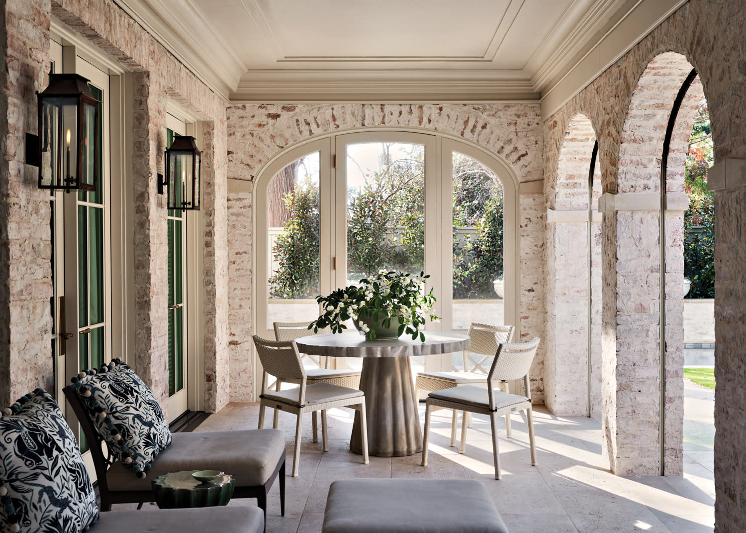 classic white brick covered terrace with a dining area