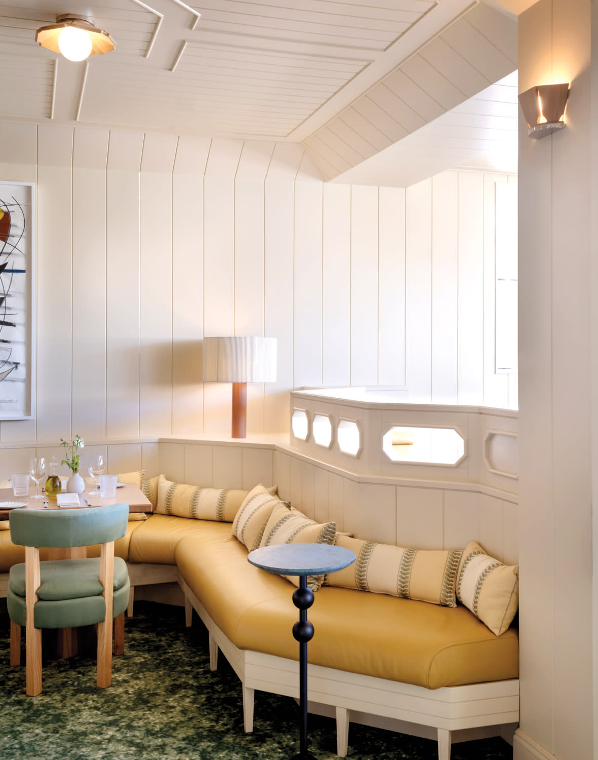 yellow and white banquette seating in white shiplap room