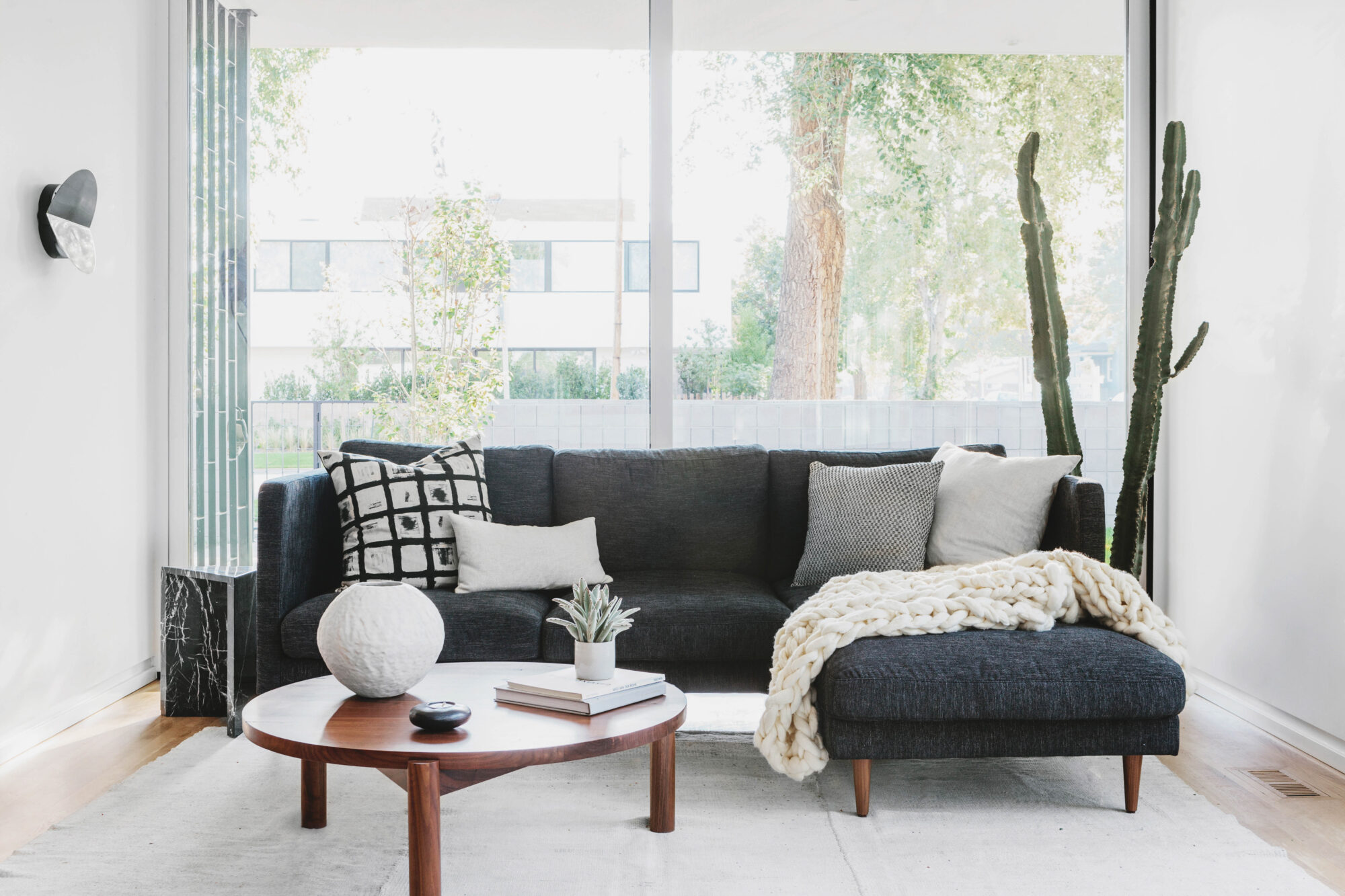 sitting area with dark couch and cozy pillows