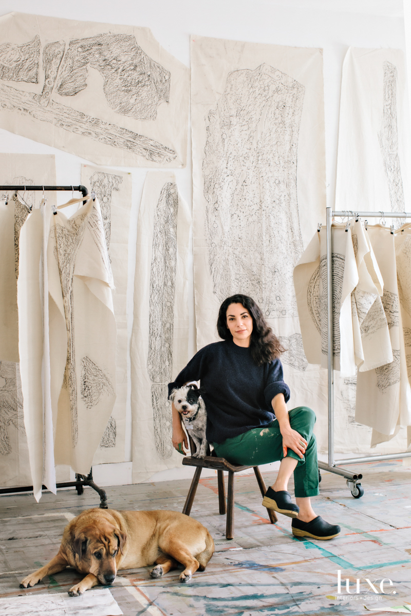 artist silverstein sits in her studio with 2 dogs