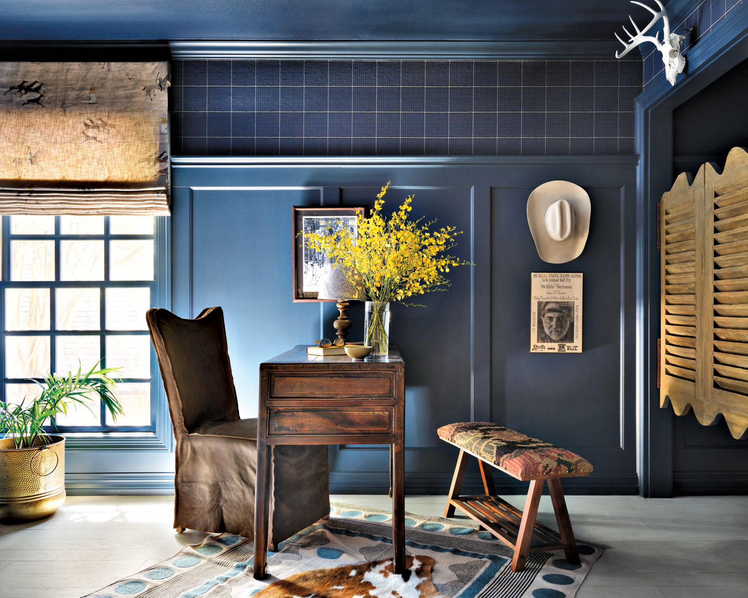 Office space with deep blue painted walls broken up with a blue checkered wallcovering