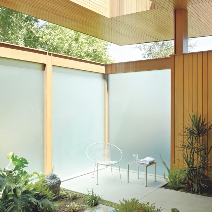 In this Pasadena, California, bathroom--a collaboration between Montalba Architects and Elysian Landscapes--concrete-and-terrazzo flooring blends with natural greenery.