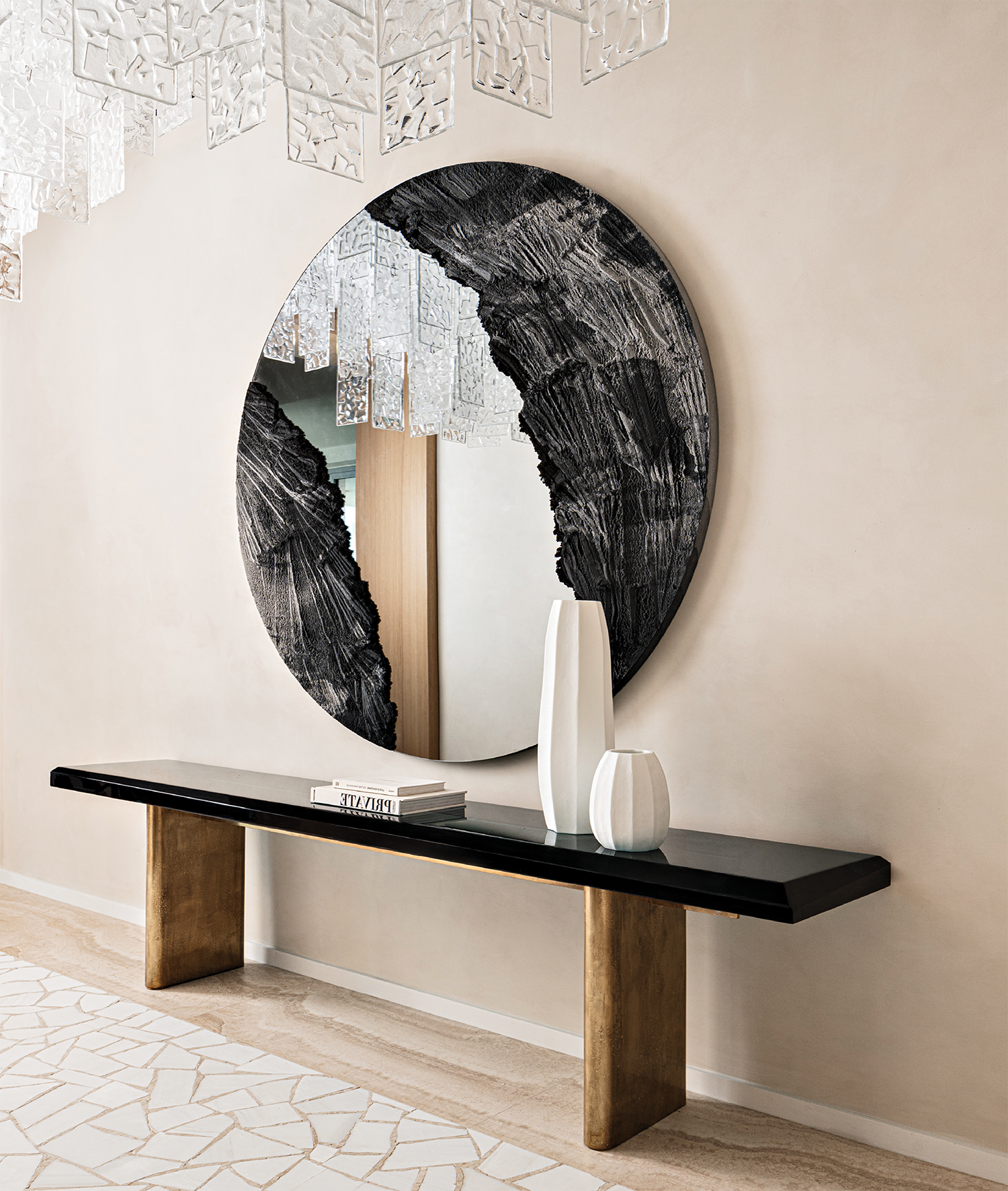 modern foyer with a glass hanging sculpture above a mirror and bench