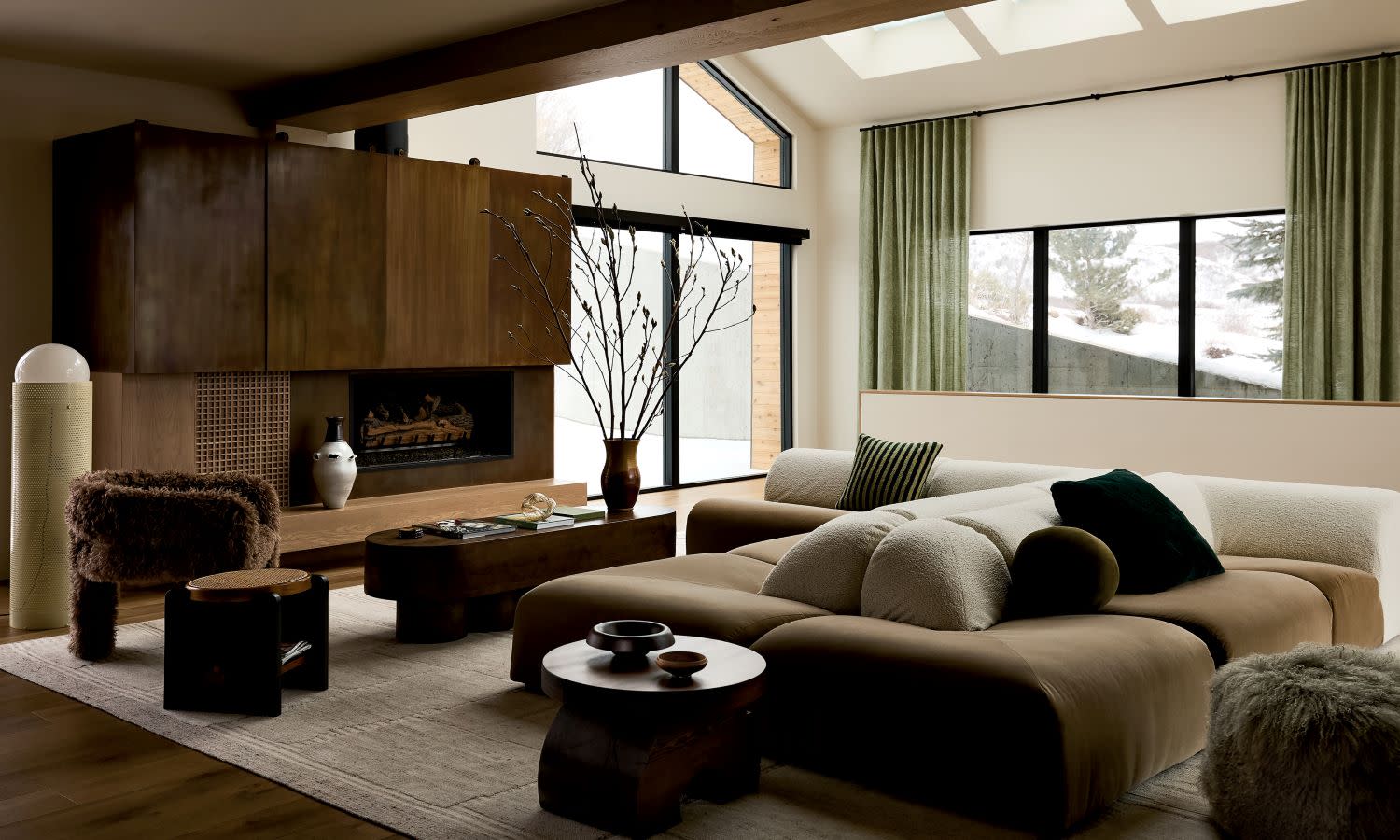 Stylish living room with a brown sectional sofa, fluffy cushions, and wood accents.
