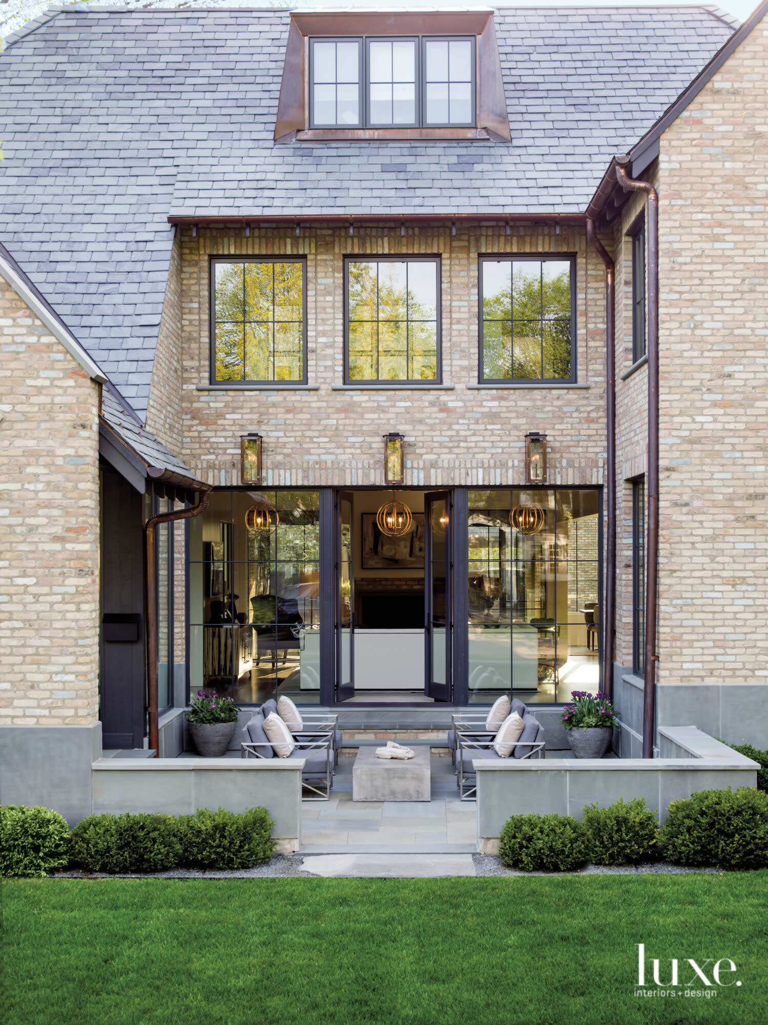 The patio view of a Belgian-bluestone modern farmhouse.