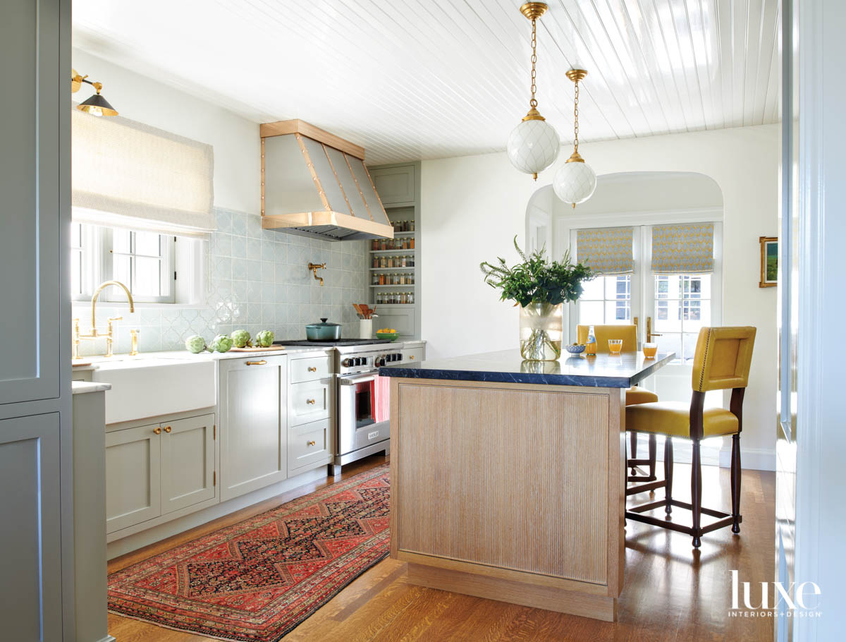 View kitchen facing sink and range and island