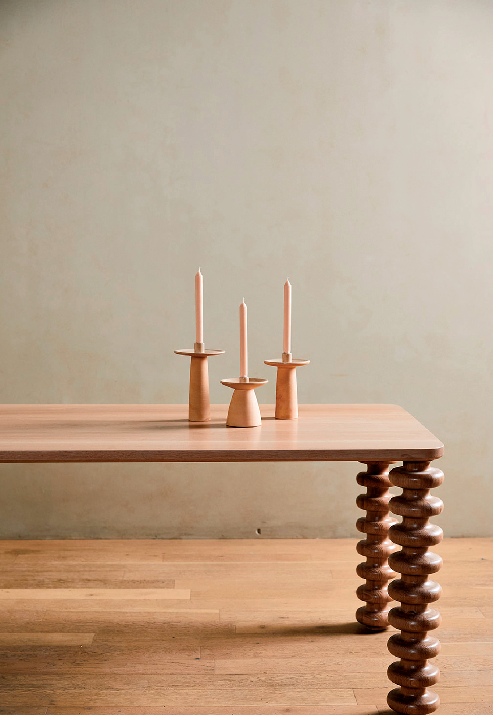 wood table topped with three candles