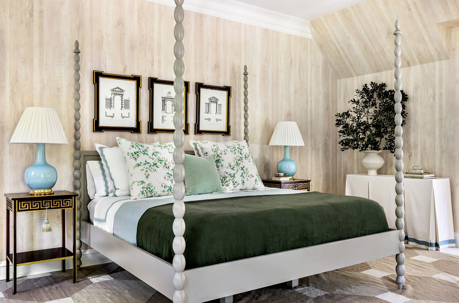 bedroom with a light brown wallcovering and classic spindle bed topped with green and white linens
