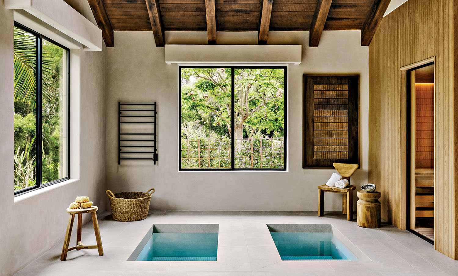 A wellness space with in-ground hot and cold plunge pools set next to a sauna.